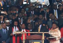Kenya's President William Ruto takes the oath of office as First Lady Rachel stands by his side during the official swearing-in ceremony in Nairobi