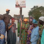 Azeez commissioning one of the signages with some Baales of Ogbo community.
